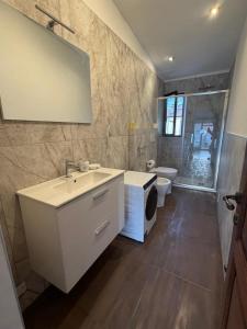 a bathroom with a sink and a shower and a toilet at Tino'S House 2punto0 in La Spezia