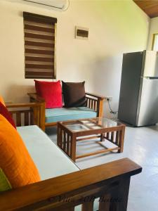 a living room with a couch and a refrigerator at Villa 40B Bentota in Bentota