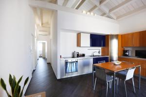 a kitchen and dining room with a table and chairs at A due passi da in Corato