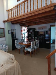 a dining room with a wooden table and chairs at Thalia in Perea +17 photos