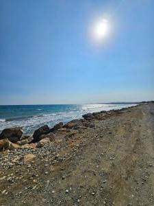 a rocky beach with the ocean in the background at Villa Kokona Private Pool Sea View in Sophtadhes