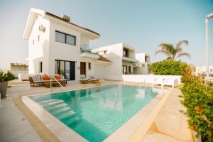 a villa with a swimming pool and a house at Villa Kokona Private Pool Sea View in Sophtadhes