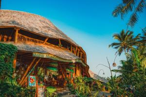 a rendering of a building with a palm tree at Green Lander Ubud in Ubud