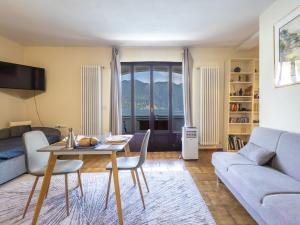 a living room with a table and a couch at Apartment Leonard Lake by Interhome in Ghiffa