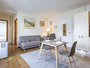 a living room with a table and a couch at Apartment Leonard Lake by Interhome in Ghiffa