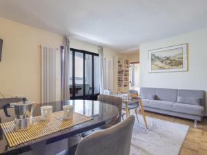a living room with a table and a couch at Apartment Leonard Lake by Interhome in Ghiffa +16 photos