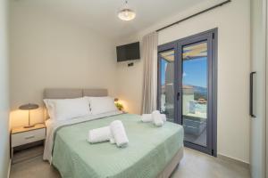 a bedroom with a bed with towels on it at Agemaya Villas in Sami +64 photos