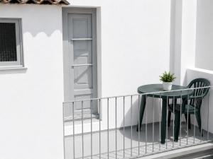 a table and a chair on a balcony at Pensión Bandrés Huesca Centro in Huesca