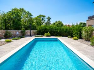 a swimming pool in the yard of a house at Villa Dream by Interhome in Dobrinj +49 photos
