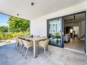 a dining room with a table and chairs at Villa Dream by Interhome in Dobrinj