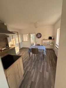 a kitchen with a table in the middle of a room at Appart Résidence Yadah RDC in Granville