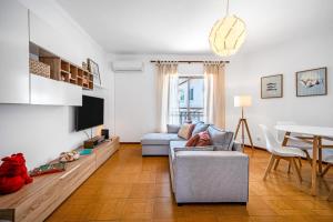 a living room with a couch and a table at BeGuest Ferragudo Sunny Apartment in Ferragudo