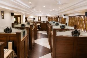 a room with a row of sinks in a salon at Hotel Sakthi in Kottayam