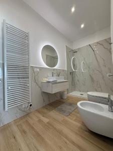 a bathroom with a sink and a toilet and mirrors at Loft09 Exclusive Suite in Lagonegro +23 photos