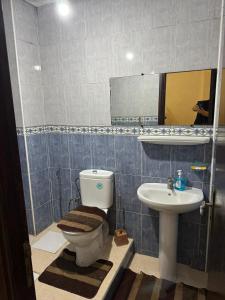 a bathroom with a toilet and a sink at maison soleil in Nouaceur