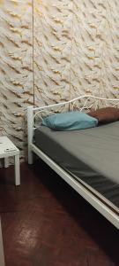 a bed in a room with a wall at W District hostel in Bangkok