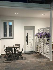 a patio with a table and chairs and a door at Piazza Apartments in Velipojë