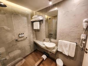a bathroom with a sink and a shower at Facón Del Mar Hotel in Mar del Plata +76 photos