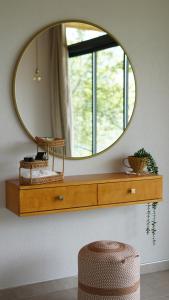 a mirror on a wall above a dresser in a room at Alaçam Tatil Evleri in Trabzon