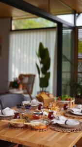 a wooden table with plates of food on it at Alaçam Tatil Evleri in Trabzon +9 photos
