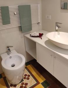 a bathroom with a toilet and a sink at Casa Ferrante in Lecce +13 photos
