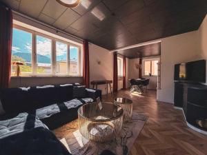 a living room with a couch and a tv at Doras Ferienhaus in Bad Reichenhall