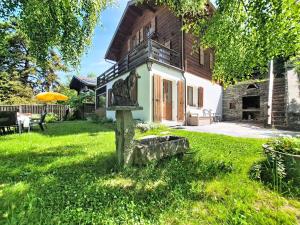 a house with a statue in the yard at Chalet Chalet Le Rhônasson by Interhome in Vercorin
