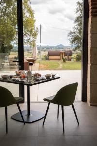 a table and chairs in a room with a window at Il Parnaso Relais in Longare