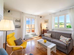 a living room with a couch and a table at Apartment Villa Elisa by Interhome in Castellina in Chianti