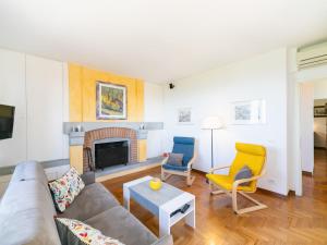 a living room with a couch and two chairs at Apartment Villa Elisa by Interhome in Castellina in Chianti +39 photos