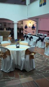 a group of tables and chairs in a room at Hotel Turístico de Tenza in Tenza