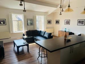 a living room with a couch and a table at Venue Apartment in Colne