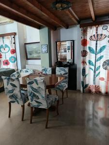 a dining room with a wooden table and chairs at Thalia in Perea