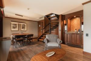 a living room with a spiral staircase and a table at Hotel Park10 in Medellín