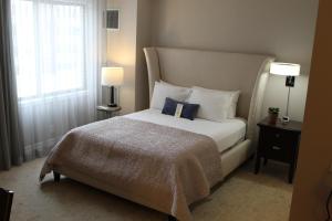 a bedroom with a bed with a blue pillow on it at Erik's Retreat in Edina