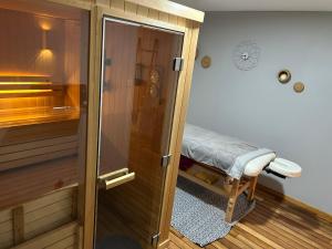 a bathroom with a sauna with a shower backdoor at Les Jardins de Valinor in Thénezay