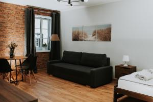 a living room with a couch and a table at Złota Brama - Old Town Apartament 2 in Gdańsk