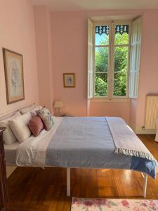 a bedroom with a large bed with a window at Chateau de La Lanette in Saléchan +55 photos