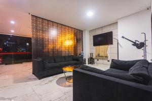 a living room with couches and a flat screen tv at HOTEL MONTANA in Bello +20 photos