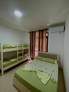 a bedroom with two bunk beds and a window at Hotel Ylberi in Golem