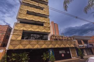 a hotel building with a lot of gold windows at HOTEL MONTANA in Bello