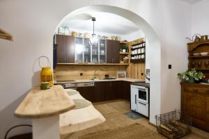 a kitchen with wooden cabinets and a table in it at Gasthaus Rokitnik in Rokity +31 photos