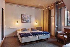 a bedroom with a bed with two pillows on it at Seglarhotellet Käringön in Käringön