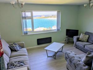 a living room with a view of the ocean at Surf View Apartments in Newquay