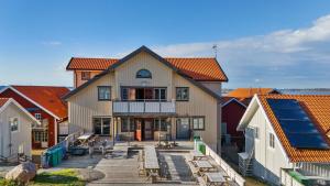 a large house with a deck in a group of buildings at Seglarhotellet Käringön in Käringön