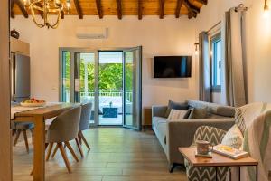 a living room with a couch and a table at Pappous workplace in Skiathos