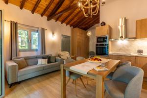 a living room with a couch and a table at Pappous workplace in Skiathos