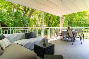 a screened in porch with a couch and a table at Pappous workplace in Skiathos