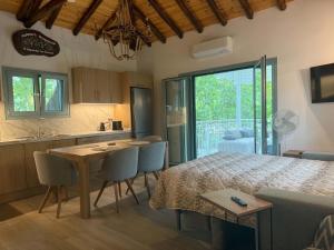 a kitchen and a bedroom with a bed and a table at Pappous workplace in Skiathos