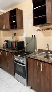 a kitchen with a stove and a sink at Caligeo Suites I in Ibadan